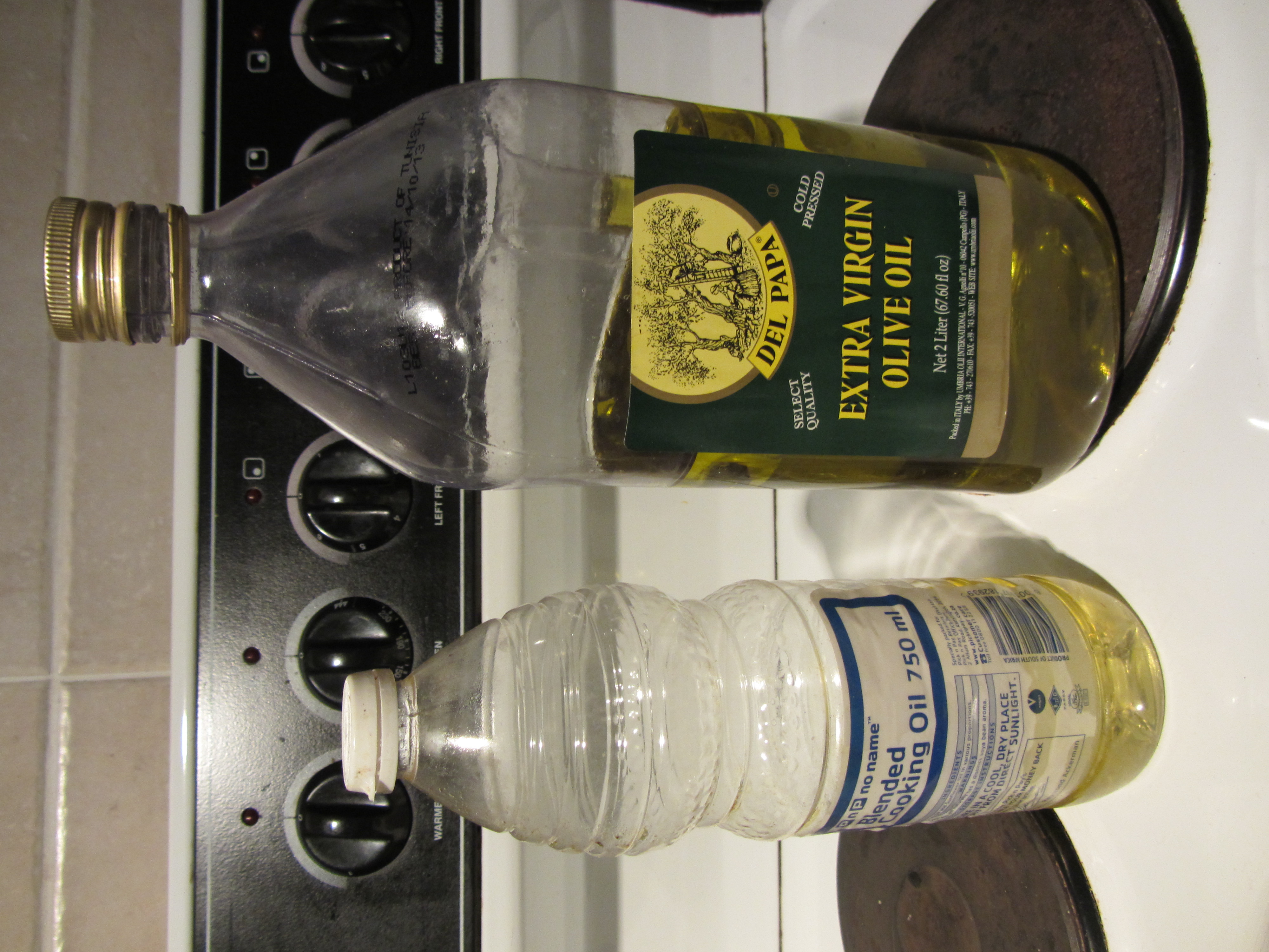 Sunflower oil and olive oil bottles on a kitchen counter