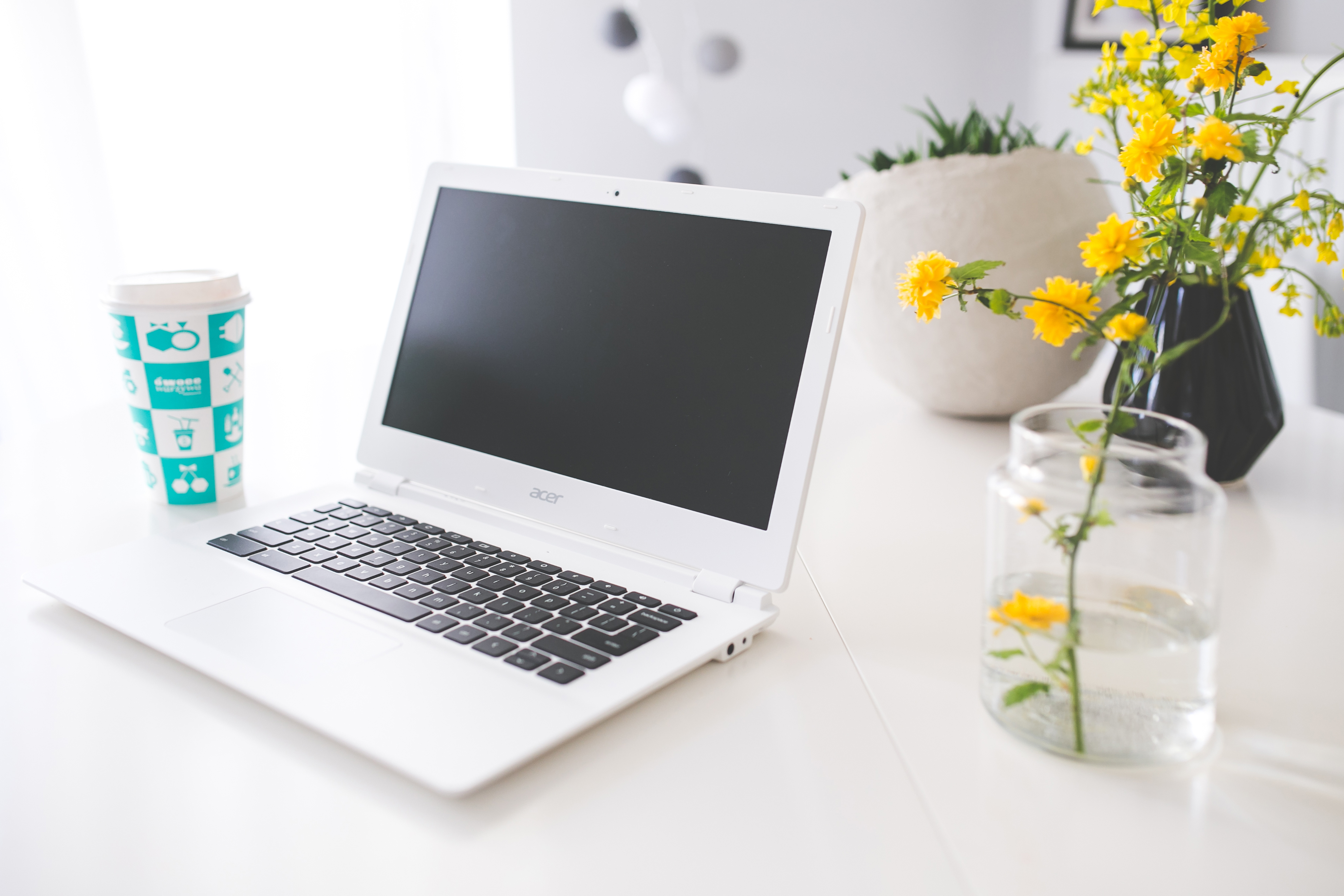 Desk setup with coffee, notebook, and laptop for daily reading and writing